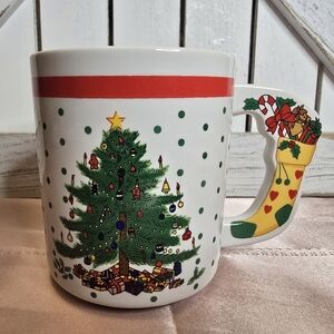 Coffee/tea mug with Christmas tree with Christmas stocking on the handle.